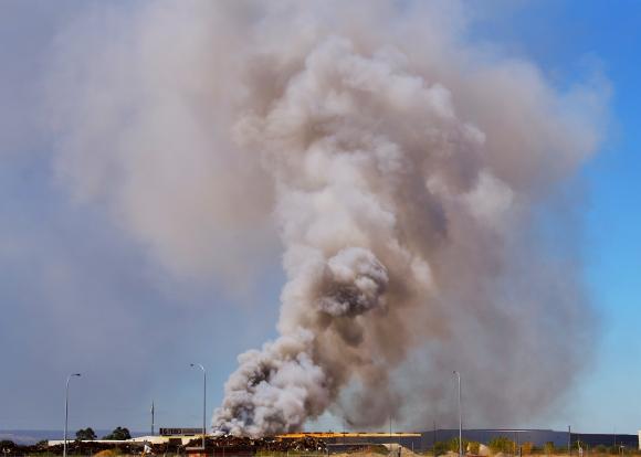 Scrapyard fire with billowing smoke